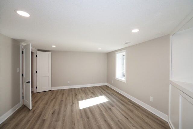 unfurnished room with light wood-type flooring