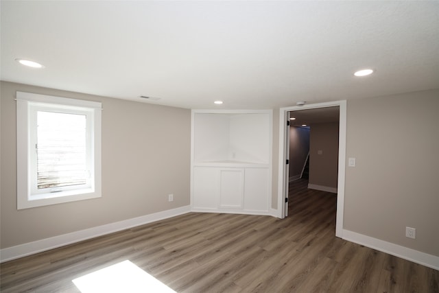 unfurnished room featuring dark wood-type flooring