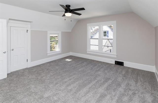 bonus room with lofted ceiling, carpet, visible vents, and baseboards