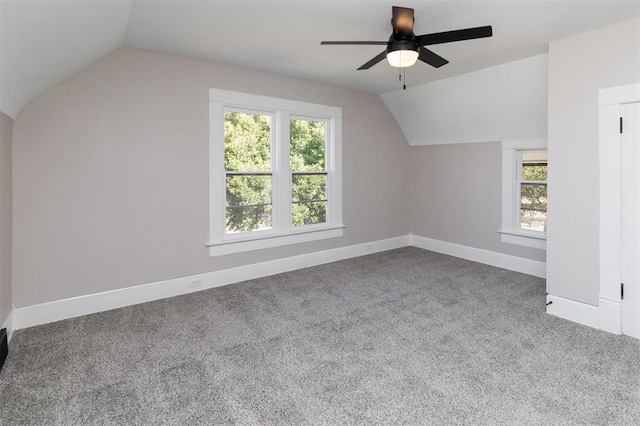 additional living space featuring carpet flooring, vaulted ceiling, baseboards, and ceiling fan