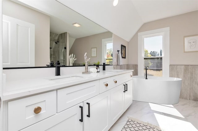 full bath featuring marble finish floor, a sink, a shower stall, and double vanity