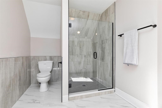 full bathroom featuring toilet, marble finish floor, and a stall shower