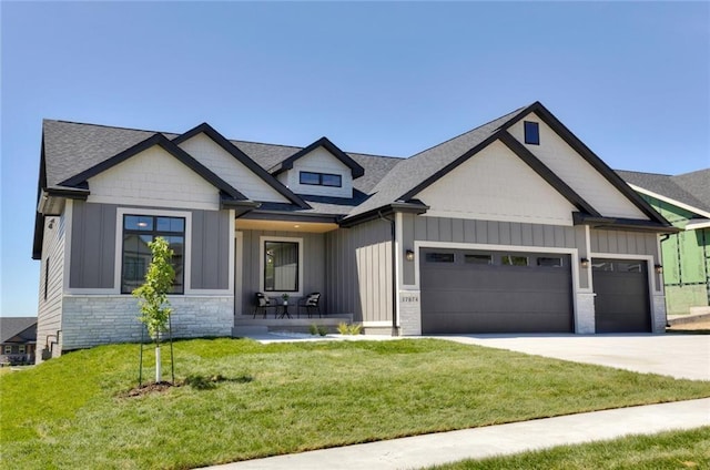 craftsman-style house with a garage and a front lawn