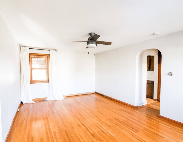 empty room with ceiling fan and light wood-type flooring