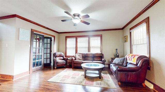 living room with crown molding, wood-type flooring, and ceiling fan