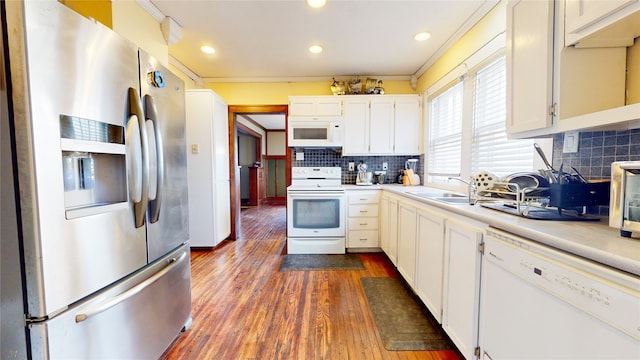 kitchen featuring white appliances, dark hardwood / wood-style flooring, white cabinetry, crown molding, and decorative backsplash