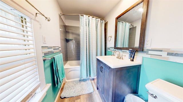 full bathroom featuring shower / tub combo, backsplash, hardwood / wood-style floors, toilet, and vanity