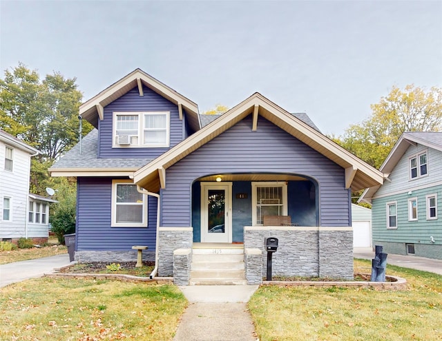 bungalow-style home with a front lawn