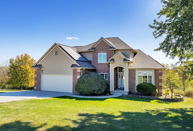 view of front of home with a garage, driveway, brick siding, and a front lawn