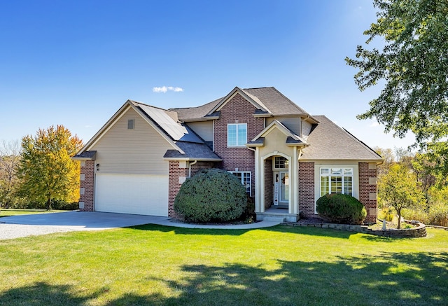 craftsman-style home featuring concrete driveway, roof with shingles, an attached garage, a front yard, and brick siding