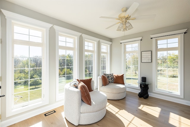 sunroom / solarium with visible vents and ceiling fan