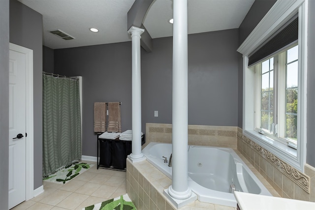 bathroom featuring tile patterned flooring, visible vents, baseboards, a jetted tub, and ornate columns