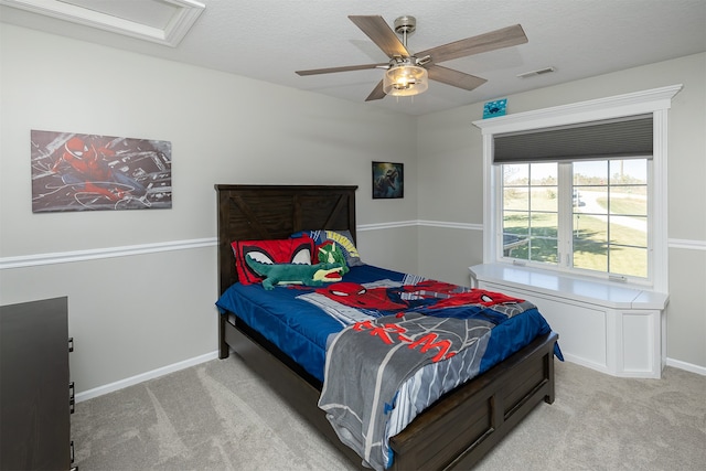 bedroom with attic access, light carpet, visible vents, and baseboards