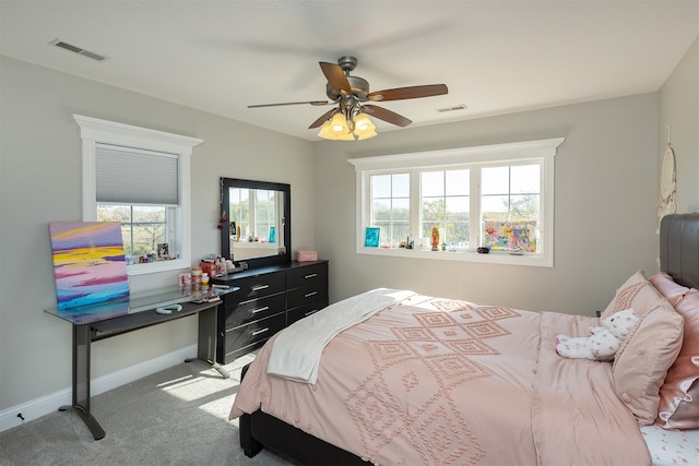 carpeted bedroom with baseboards, multiple windows, and visible vents