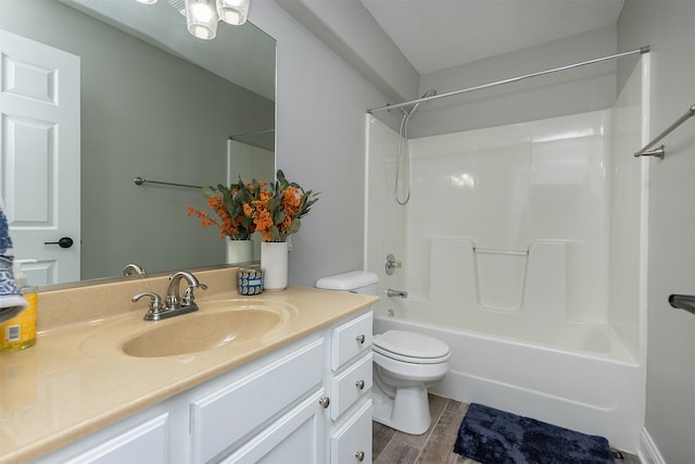 bathroom featuring wood tiled floor, tub / shower combination, vanity, and toilet