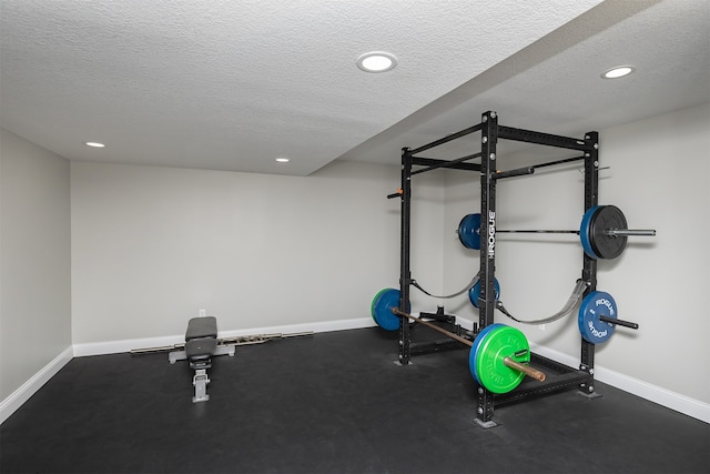 workout room featuring baseboards, a textured ceiling, and recessed lighting