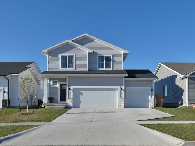 front facade featuring a front lawn and a garage