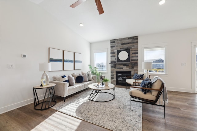 living room with a large fireplace, dark hardwood / wood-style floors, ceiling fan, and lofted ceiling