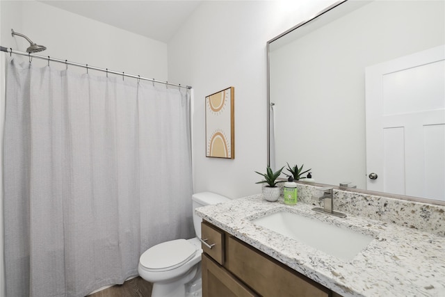 bathroom with hardwood / wood-style floors, vanity, and toilet