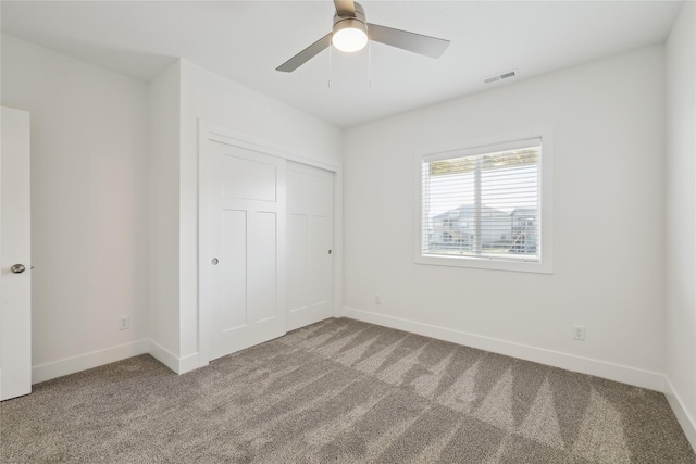 unfurnished bedroom featuring carpet, a closet, and ceiling fan