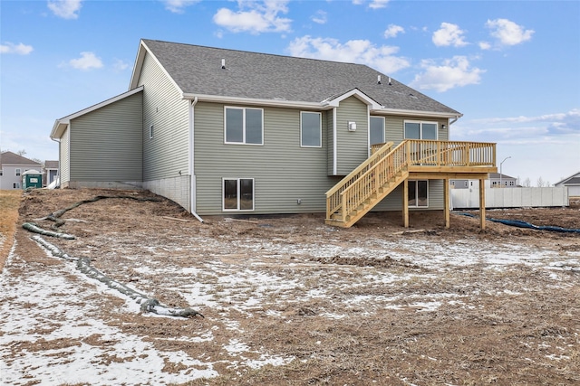 snow covered rear of property featuring a wooden deck