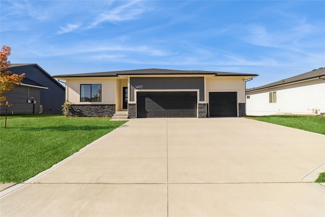 prairie-style home with a front lawn and a garage