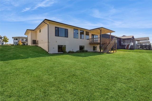 rear view of property featuring a wooden deck, cooling unit, and a lawn