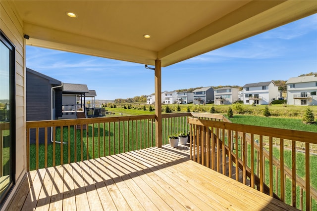 wooden terrace featuring a lawn