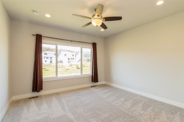 carpeted empty room featuring ceiling fan