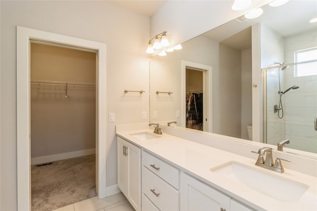 bathroom featuring vanity, tile patterned flooring, toilet, and an enclosed shower