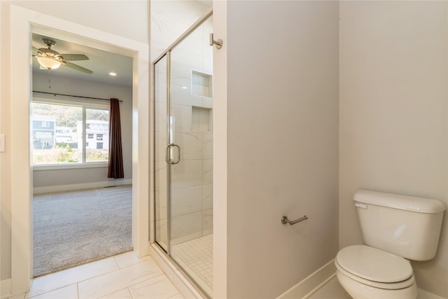 bathroom featuring toilet, walk in shower, and ceiling fan