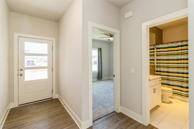 doorway to outside featuring light hardwood / wood-style flooring and ceiling fan