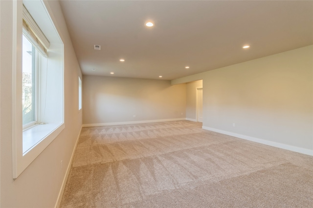 unfurnished room featuring light colored carpet