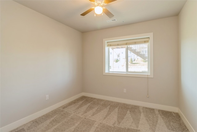 carpeted empty room featuring ceiling fan