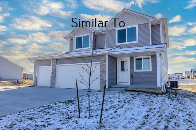 view of property featuring a garage and central air condition unit