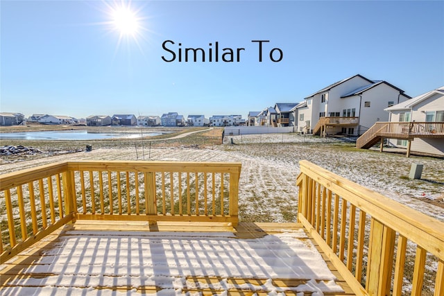 wooden terrace featuring a water view and a residential view