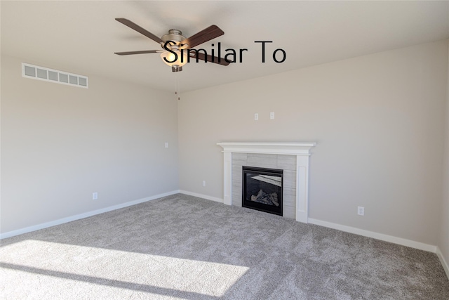 unfurnished living room with visible vents, baseboards, a tile fireplace, ceiling fan, and carpet