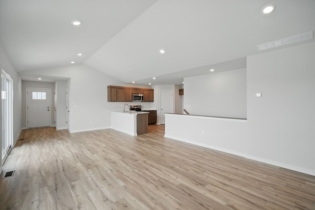unfurnished living room featuring lofted ceiling, visible vents, light wood-type flooring, and recessed lighting