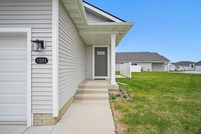 property entrance with a yard