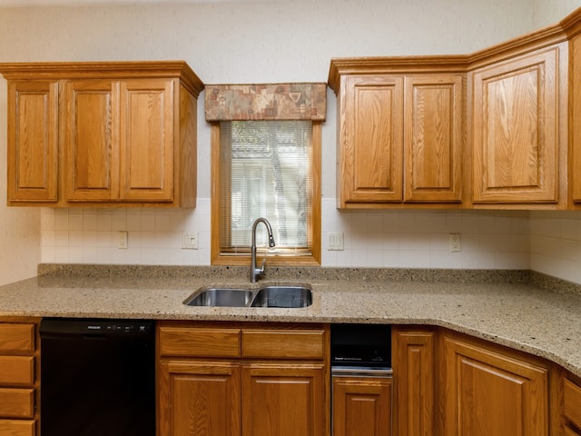 kitchen with black dishwasher, sink, tasteful backsplash, and light stone counters