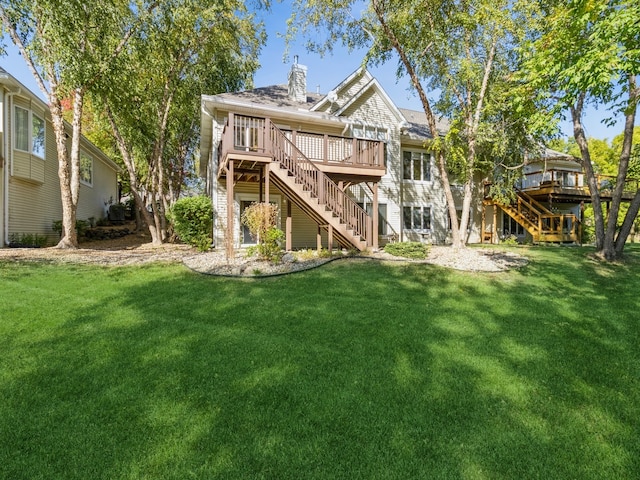 back of house with a yard and a wooden deck