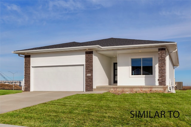 view of front of property with cooling unit, a garage, and a front lawn