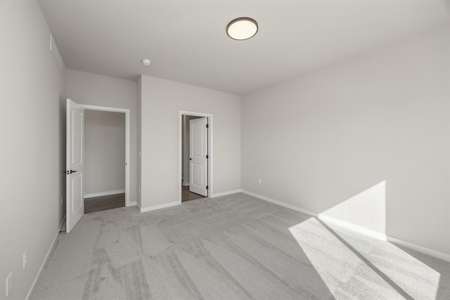 unfurnished bedroom featuring baseboards and carpet