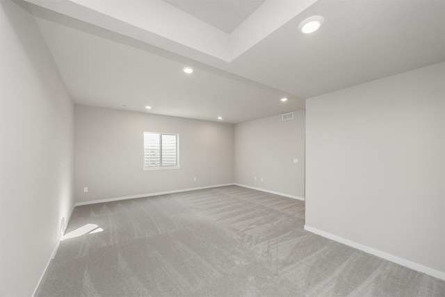 carpeted spare room featuring recessed lighting, visible vents, and baseboards