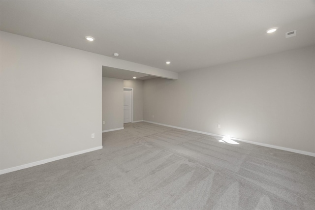 empty room with visible vents, recessed lighting, baseboards, and light carpet