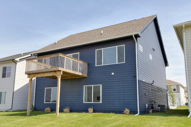 rear view of property featuring cooling unit and a yard