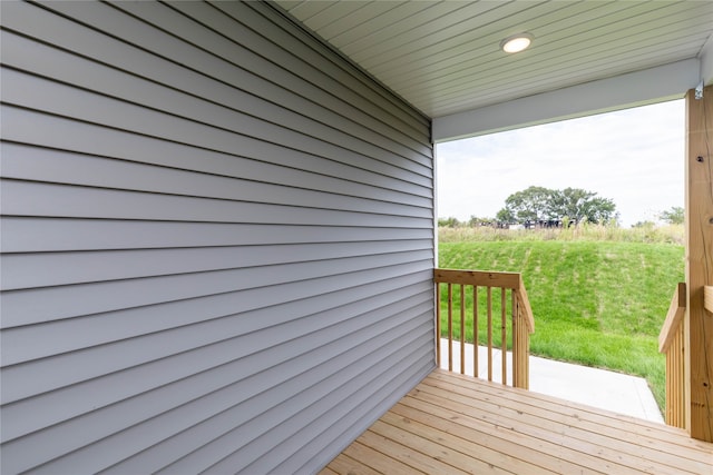 wooden deck with a lawn