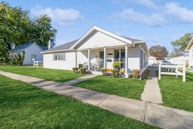 bungalow-style home featuring covered porch and a front yard