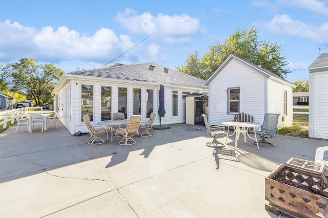 back of house featuring an outdoor fire pit and a patio