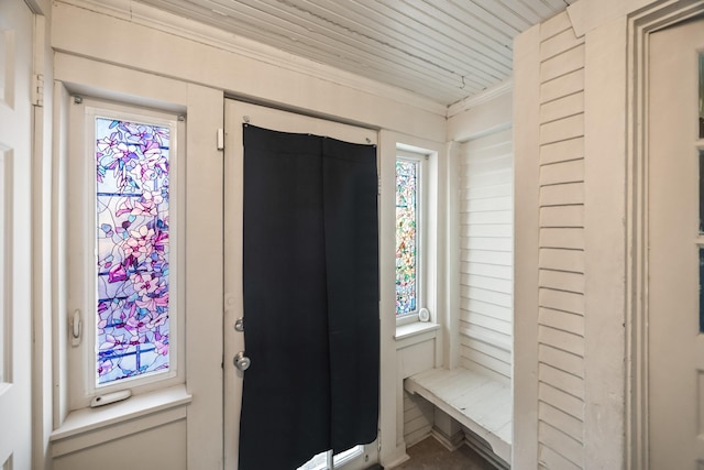 foyer entrance with wooden ceiling and ornamental molding